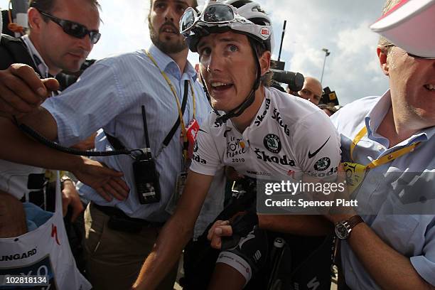 Andy Schleck of Luxembourg from team Saxo Bank is surrounded by the media and his team after winning stage eight of the Tour de France July 11, 2010...