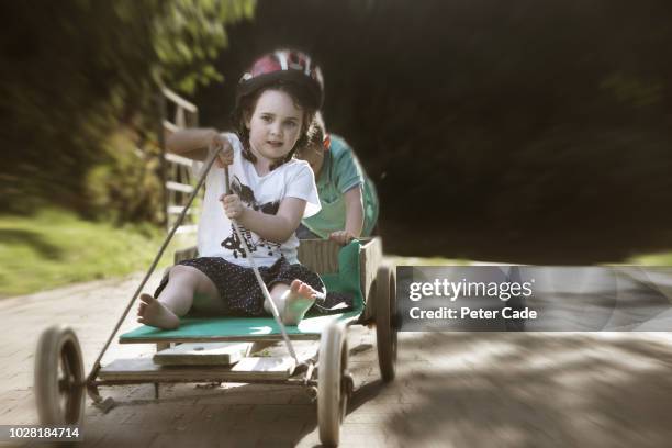 brother and sister playing on homemade go-kart - boy skirt stock pictures, royalty-free photos & images