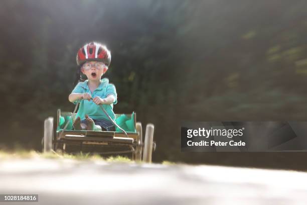 little boy playing on homemade go-kart - auto pilot stock pictures, royalty-free photos & images