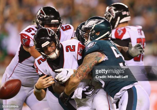 Matt Ryan of the Atlanta Falcons fumbles the ball as he is hit by Chris Long of the Philadelphia Eagles during the fourth quarter at Lincoln...