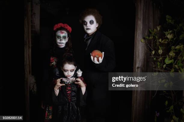 three kids in spooky halloween costumes in door of barn - ghost player stock pictures, royalty-free photos & images