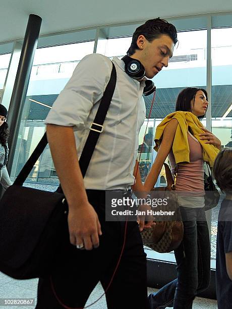 Mesut Oezil and his girlfriend Anna-Maria Lagerblom walking through the terminal between the german national team arrival on July 12, 2010 in...