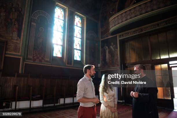 Prince Nicholas Of Romania and Princess Alina Of Romania speak to a priest, at the Stabtul Illie Church on August 05, 2018 in Sinaia, Romania.