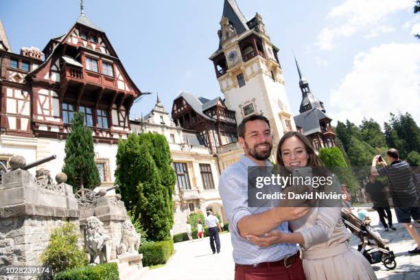 Prince Nicholas Of Romania and Princess Alina Of Romania pose in front of the Peles Castle on August 05, 2018 in Sinaia, Romania.