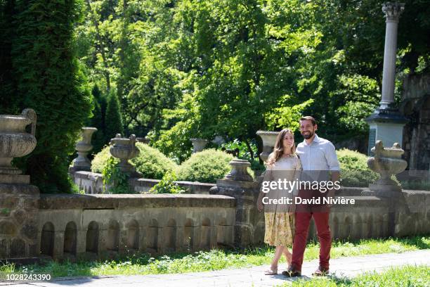 Prince Nicholas Of Romania and Princess Alina Of Romania hold hands while walking at the Peles Castle on August 05, 2018 in Sinaia, Romania.