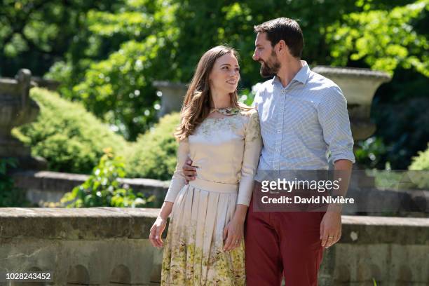 Prince Nicholas Of Romania and Princess Alina Of Romania hold hands while walking at the Peles Castle on August 05, 2018 in Sinaia, Romania.