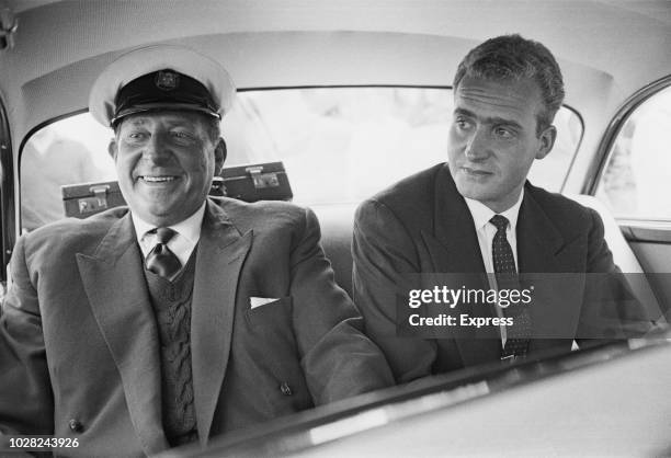 Infante Juan, Count of Barcelona pictured on left with his son Prince Juan Carlos de Borbon, heir to the Spanish throne, in the rear seat of a car at...