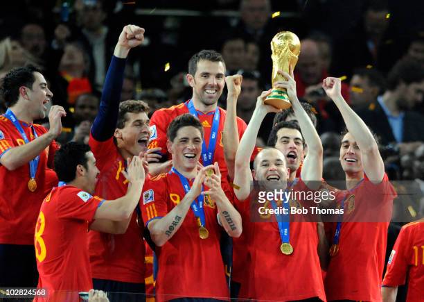 Andres Iniesta of Spain lifts the trophy and celebrates with team-mates after the 2010 FIFA World Cup Final between the Netherlands and Spain on July...