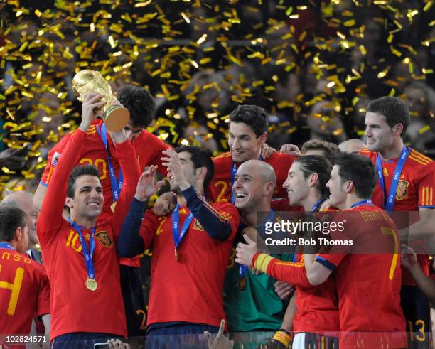 Cesc Fabregas of Spain lifts the trophy and celebrates with team-mates after the 2010 FIFA World Cup Final between the Netherlands and Spain on July...