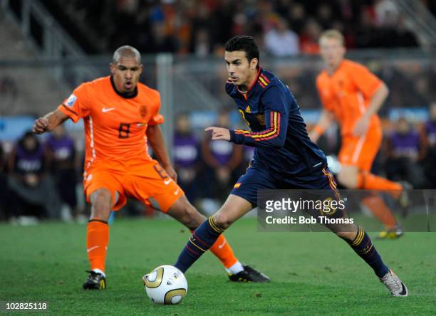 Pedro of Spain watched by Nigel De Jong of the Netherlands during the 2010 FIFA World Cup Final between the Netherlands and Spain on July 11, 2010 in...