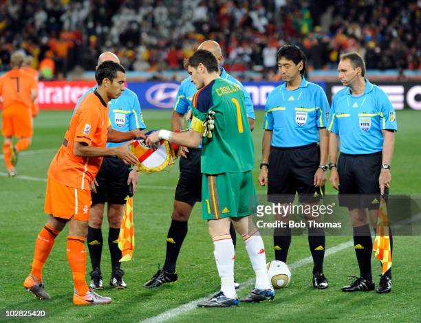 The Netherlands captain Giovanni Van Bronckhorst exchanges pennants with Spanish captain Iker Casillas before the start of the 2010 FIFA World Cup...