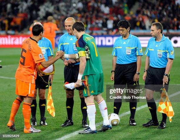 The referee Howard Webb looks on as the Netherlands captain Giovanni Van Bronckhorst shakes hands with Spanish captain Iker Casillas before the start...