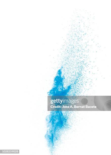 explosion by an impact of a cloud of particles of powder of color blue on a white background. - powder blue ストックフォトと画像