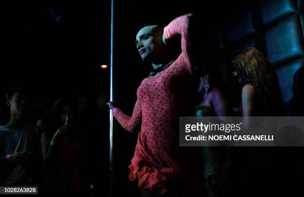 Indian revellers party at the 'Kitty Su' nightclub in the Lalit Hotel in New Delhi in the early morning of September 7 as members and supporters of...