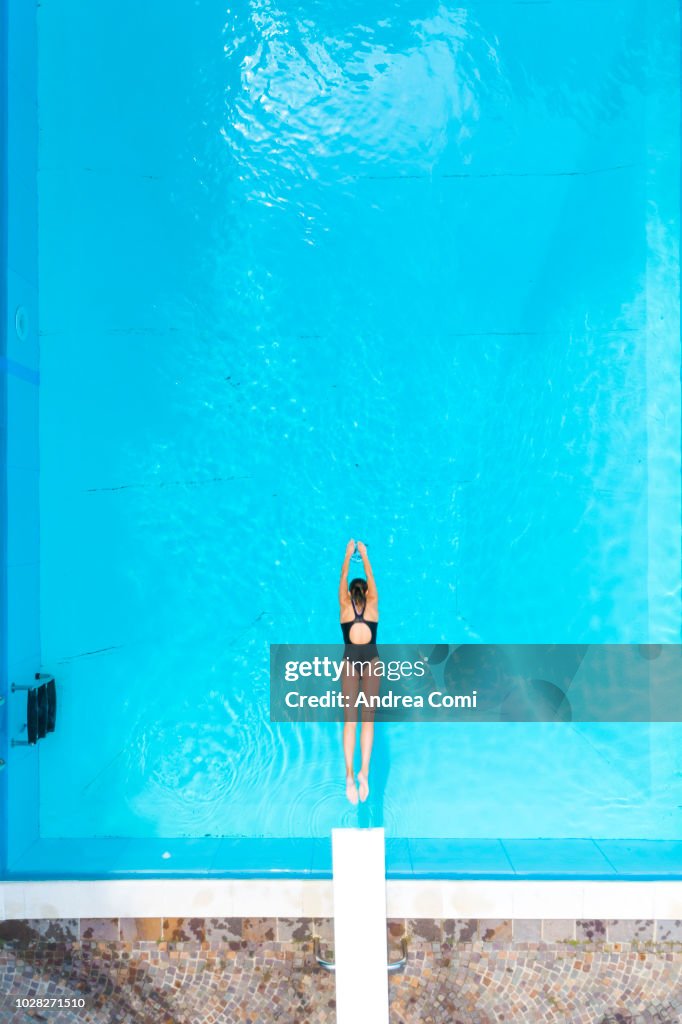 Aerial View Of Woman Diving Into Swimming Pool High-Res Stock Photo ...