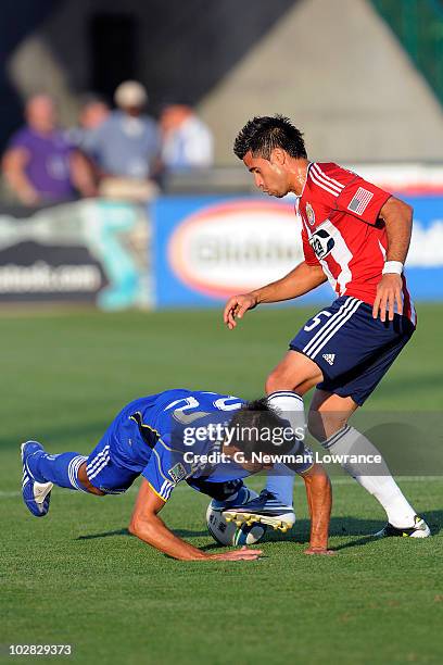 Davy Arnaud of the Kansas City Wizards is upended by Marcelo Saragosa of Chivas USA on July 10, 2010 at Community America Park in Kansas City,...