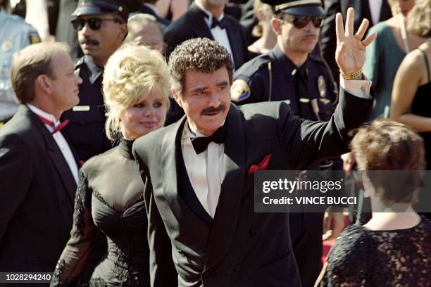 Actor Burt Reynolds waves to the crowd upon his arrival with his wife Loni Anderson at the 44th Annual Emmy Awards in Pasadena on August 30 as he is...