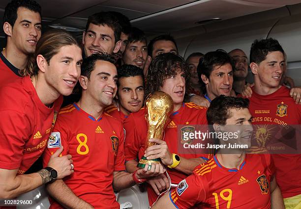 Sergio Ramos, Xavi Hernandez, Pedro Rodriguez, Carles Puyol, Fernando Llorente and Fernando Torres celebrate with the World Cup trophy during the...