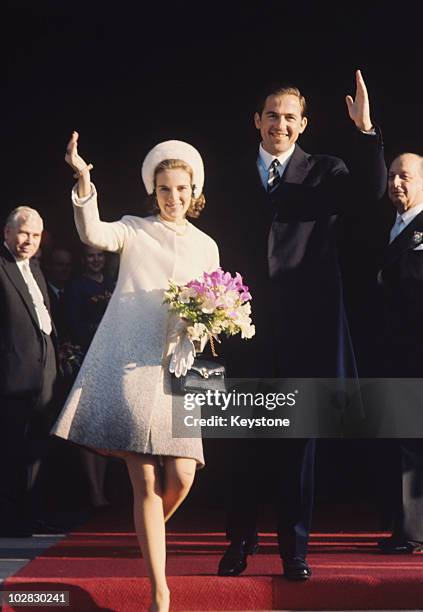 King Constantine II of Greece and Queen Anne-Marie of Greece, holding a bouquet of flowers, both waving, in Copenhagen, Denmark, 11 March 1969. The...