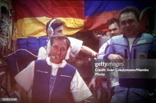 German astronaut Klaus Dietrich Flade and Russian cosmonauts aboard Russian MIR space station are seen live on a screen of the Control Center in...