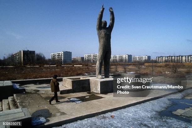 Baikonur inhabitants walk past propaganda signs that show images of Russia�s space history, on March 16 in Baikonur, Kazakhstan. Baikonur, located in...