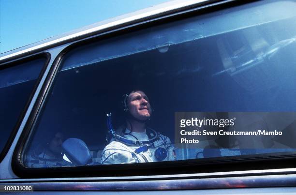 German astronaut Klaus Dietrich Flade looks out of the window of a bus that brings him and Russian cosmonauts to the spacecraft that will take them...