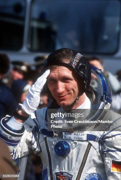 German astronaut Klaus Dietrich Flade salutes to Russian military officials prior to boarding the spacecraft that will take them to the Mir space...