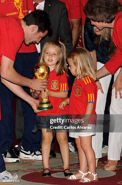 Princess Leonor of Spain holds the trophy with goalkeeper and captain Iker Casillas, watched by Princess Sofia, Princess Letizia and Queen Sofia of...