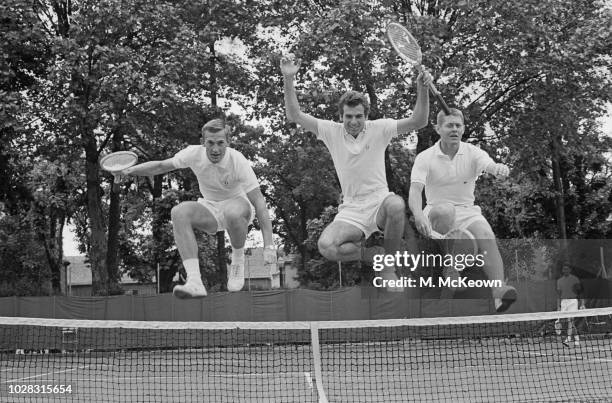Australian tennis player Tony Roche, Brazilian tennis player Thomaz Koch, and American tennis player Cliff Richey jumping a tennis net while at the...