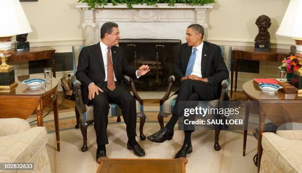 President Barack Obama meets with President Leonel Fernandez of the Dominican Republic in the Oval Office of the White House in Washington on July...