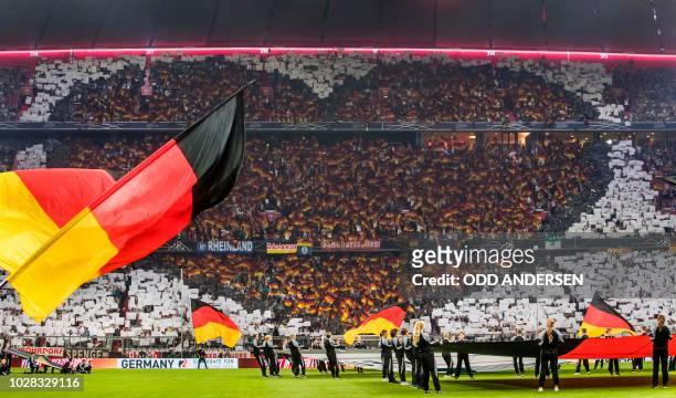 German football fans are making a heart shape tribute to their team prior to kick off in the UEFA Nations League football match Germany against...