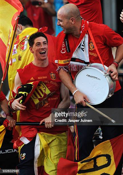 Fernando Torres of Spain celebrates with his teammate goalkeeper Pepe Reina during the Spanish team's victory parade following their victory in the...