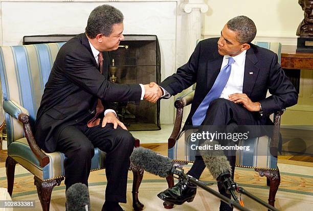 President Barack Obama and Leonel Fernandez, president of the Dominican Republic, shake hands after a bilateral meeting in the Oval Office of the...