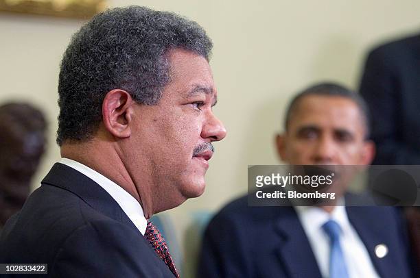 President Barack Obama listens as Leonel Fernandez, president of the Dominican Republic, speaks after a bilateral meeting in the Oval Office of the...