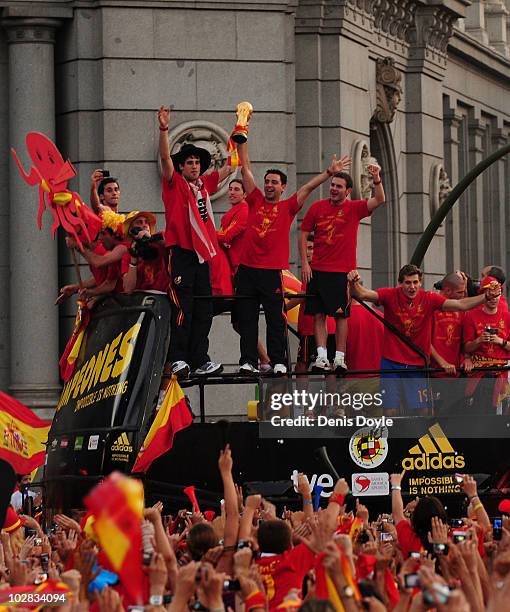 Xavi Hernandez holds aloft the FIFA World Cup to the crowds gathered in Plaza Cibeles on July 12, 2010 in Madrid, Spain after Spain won the FIFA...