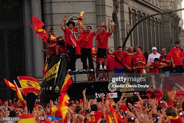 Xavi Hernandez holds aloft the FIFA World Cup to the crowds gathered in Plaza Cibeles on July 12, 2010 in Madrid, Spain after Spain won the FIFA...