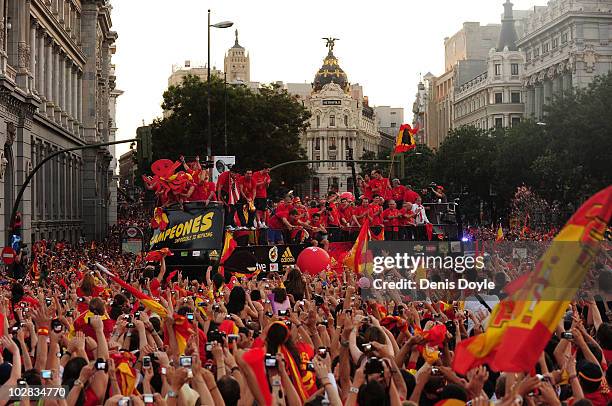 Crowds cheer the Spanish team on an open bus in Plaza Cibeles on July 12, 2010 in Madrid, Spain after Spain won the FIFA World Cup.