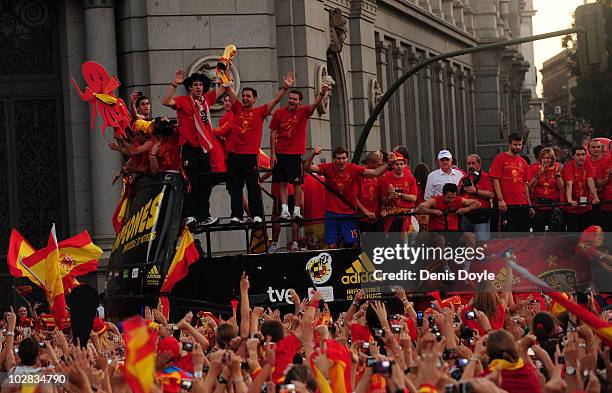 Xavi Hernandez holds aloft the FIFA World Cup to the crowds gathered in Plaza Cibeles on July 12, 2010 in Madrid, Spain after Spain won the FIFA...