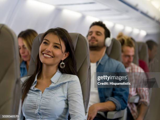 happy woman traveling by plane - plane seat stock pictures, royalty-free photos & images