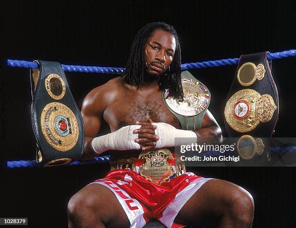 World Heavyweight Champion Lennox Lewis of Great Britain shows off his IBO, WBC and WBA title belts during a feature shoot in London. \ Mandatory...