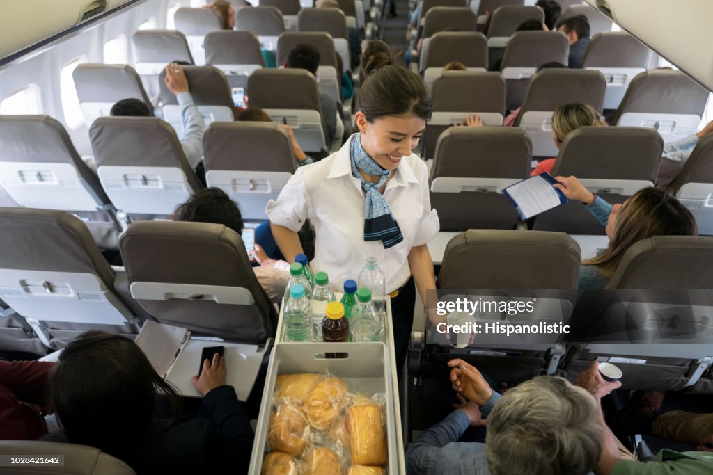 Air hostess serving food and drinks onboard