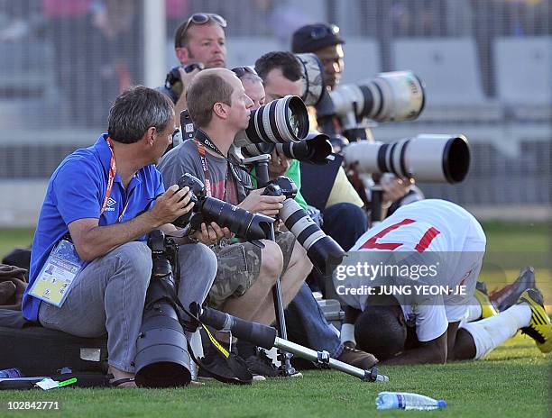 England national football team Shaun Wright-Phillips falls down in front of photographers during a public training match against South African local...