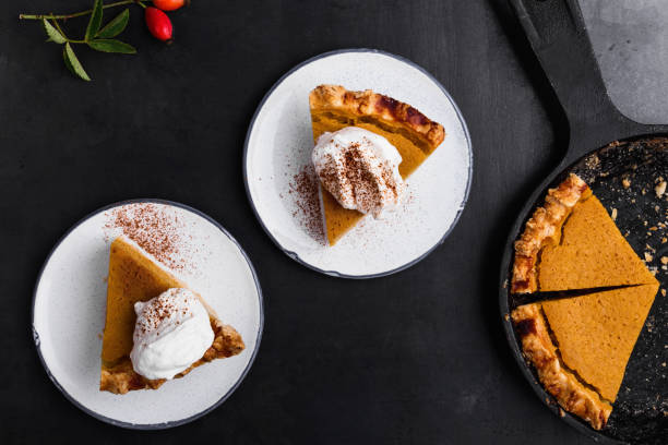pumpkin pie slices served on a plate - thanksgiving desserts stock photos and pictures