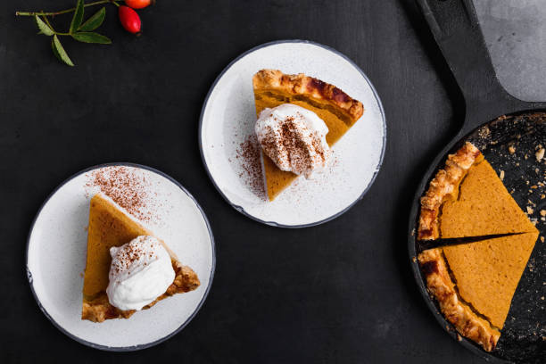 slices of pumpkin pie served on plate - thanksgiving desserts stock pictures, royalty-free photos & images