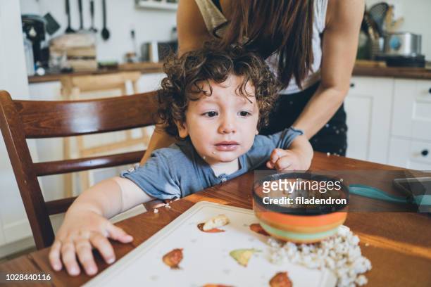 eating lunch and making mess - family chaos stock pictures, royalty-free photos & images