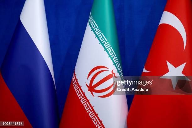 Flags of Russia, Iran and Turkey are seen during joint press conference after the trilateral summit between Turkey, Iran and Russia on September 7,...