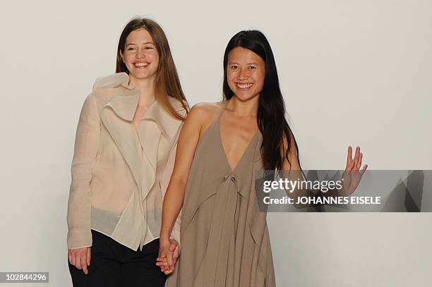 The designers Johanna Perret und Tutia Shaad of the label "Perret Schaad" wave to the audience during the Berlin Fashion Week on July 10, 2010 in...