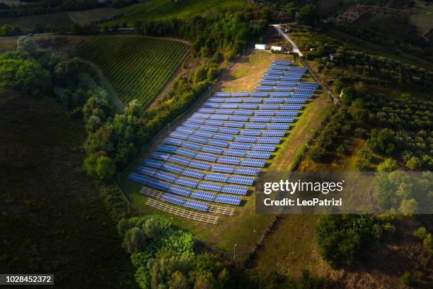 solar panels fields on the green hills - electrical grid imagens e fotografias de stock