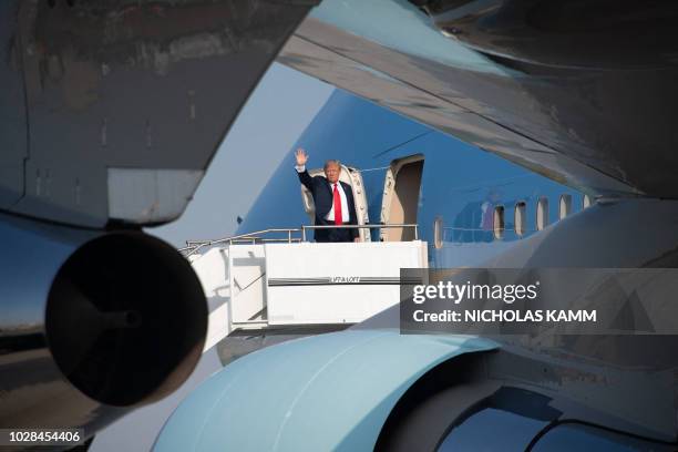 President Donald Trump boards Air Force One as he departs from Billings Logan International Airport in Billings, Montana, on September 7, 2018. Trump...
