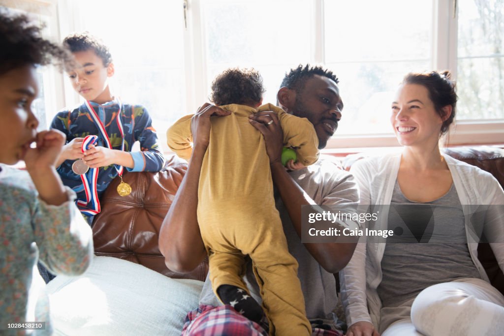 Happy multi-ethnic family on sofa